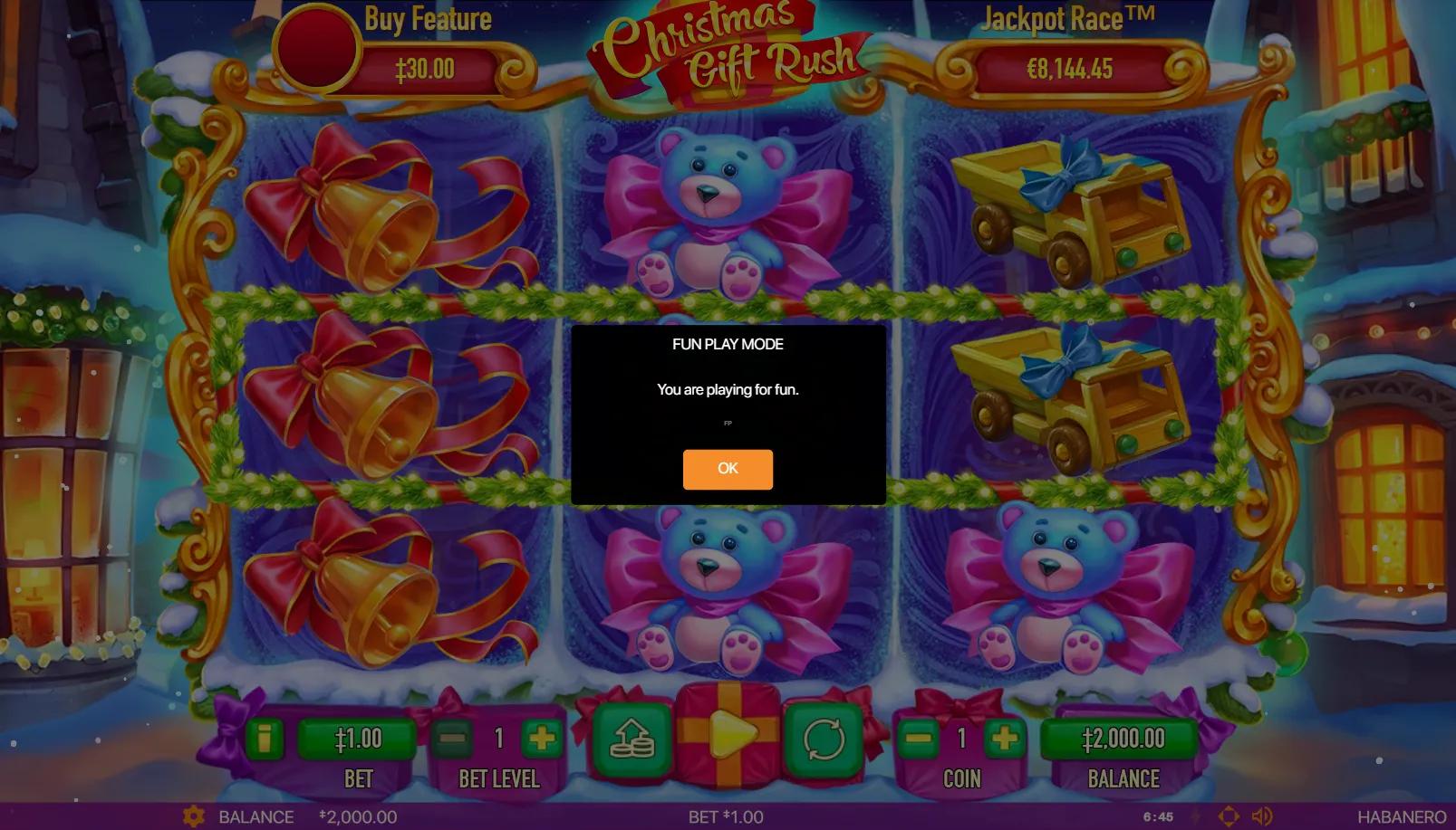 Christmas Gift Rush slot gameplay showing 3x3 grid with toy truck, teddy bear and gold bell symbols inside ornate gilded frame on snowy winter village backdrop