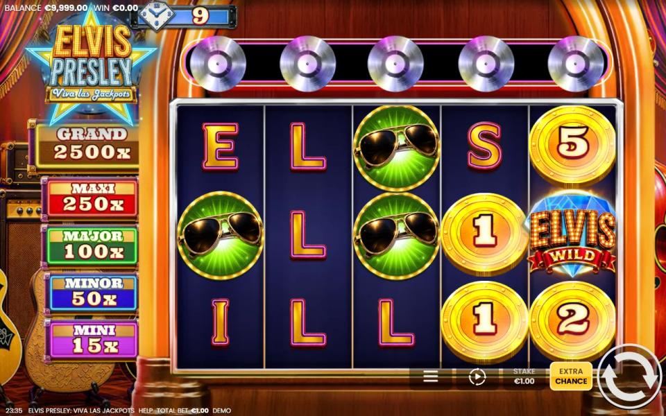 Elvis Presley Viva Las Jackpots 5x3 reels with Golden Coins and an Elvis Wild, five silver Records above the reels and the Mini to Grand jackpot ladder on the left