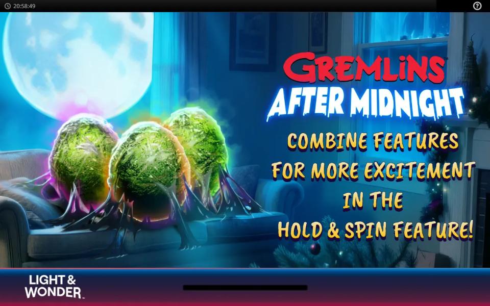 Gremlins After Midnight loading screen with three Mogwai on a sofa and the line COMBINE FEATURES FOR MORE EXCITEMENT IN THE HOLD AND SPIN FEATURE