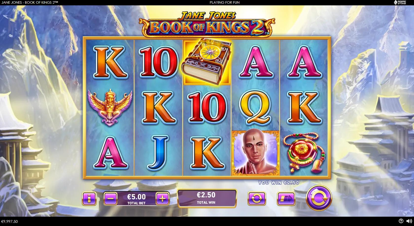 Jane Jones Book of Kings 2 gameplay showing a 5x3 Himalayan reel set with the heroine, a monk, a Garuda deity and the sun Day Book