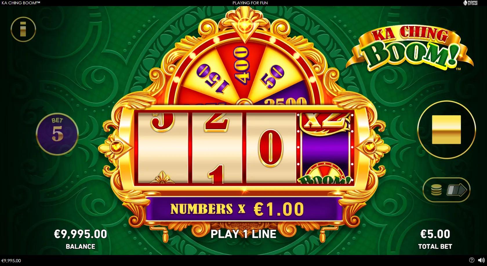 Ka Ching Boom slot: ornate 4-reel numbers machine with a multiplier reel and a gold prize wheel above the reels