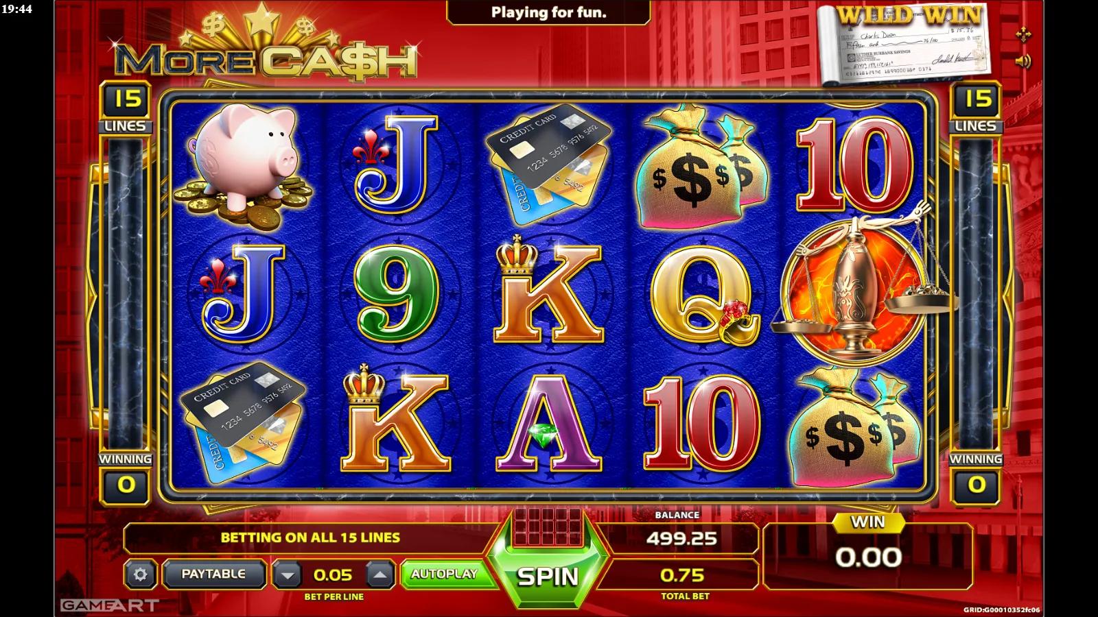More Cash slot gameplay showing the 5x3 money grid with dollar bills, a money bag, piggy bank and scales symbols across 15 lines