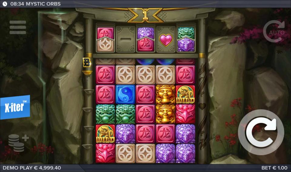 Two blue orbs dropping into the middle columns of the Mystic Orbs grid with the feature row above holding upgrade tiles and an extra life heart