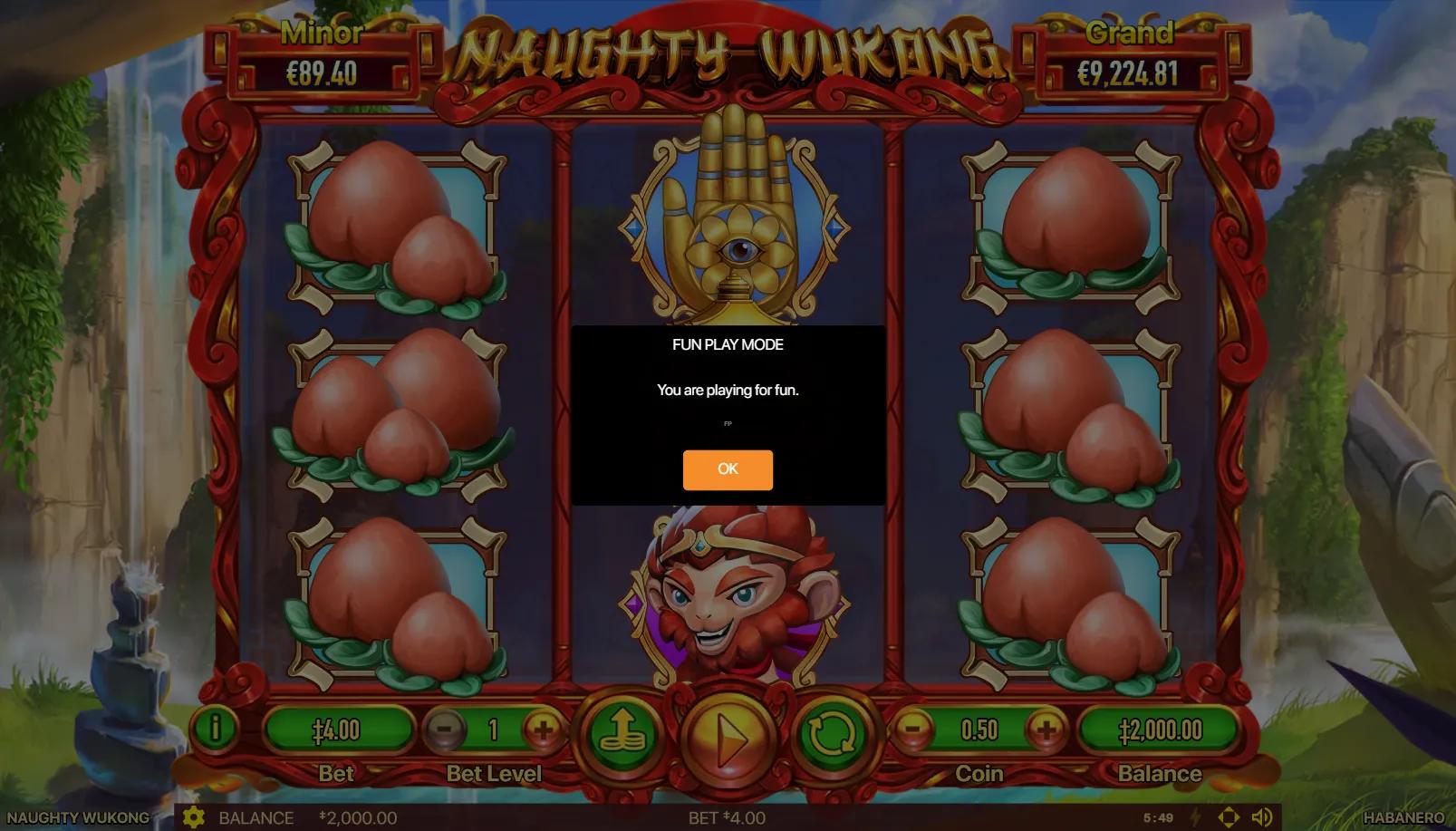 Naughty Wukong slot gameplay showing 3x3 grid with Monkey King, pagoda and peach of immortality symbols on jade mountain waterfall backdrop