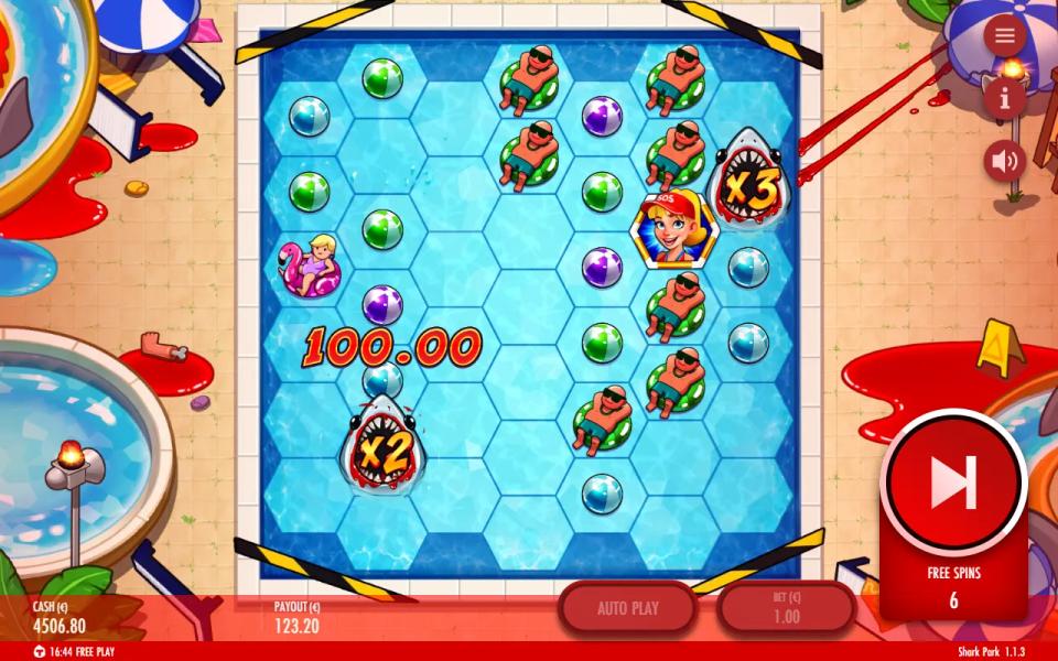 Shark Park free spins on the hexagonal pool grid, a 100.00 win marked beside an x2 shark wild with an x3 shark on the right edge