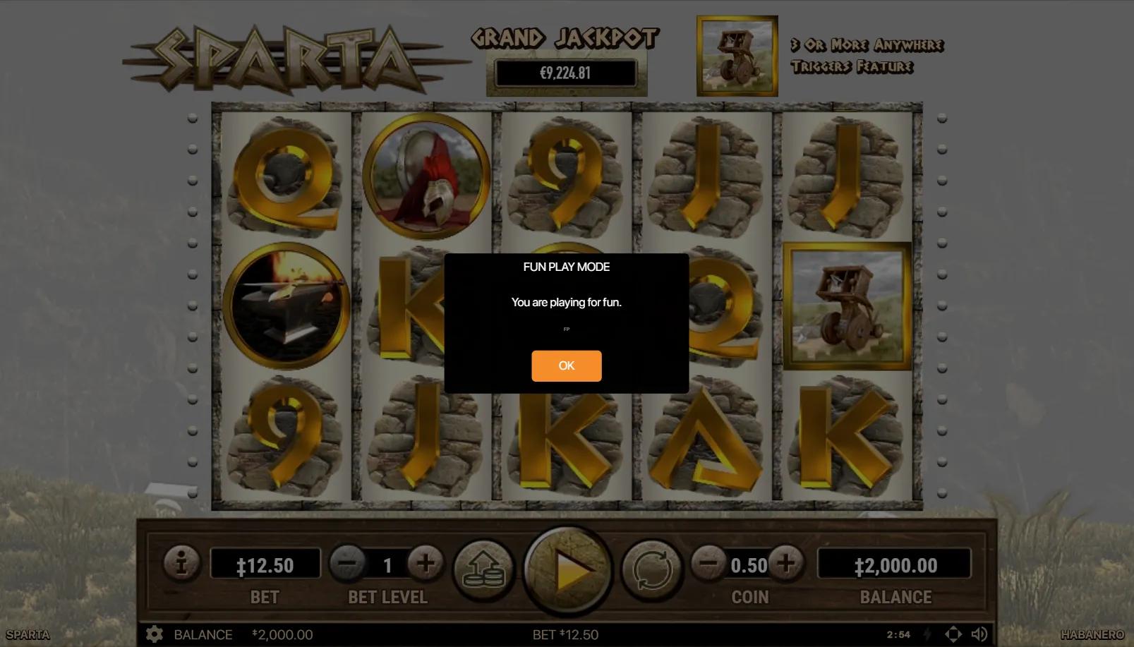 Sparta slot gameplay showing 5x3 grid with helmet, anvil, ballista scatter and stone-tablet royals on dusty Greek battlefield
