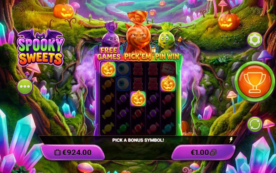 Spooky Sweets 5x5 board with three glowing pumpkins on reels 1, 3 and 5 under the purple, orange and green candy characters labelled Free Games, Pick'em and Pin Win